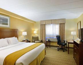 Guest room in Holiday Inn Express Philadelphia Airport, with double bed and chair/desk for working.