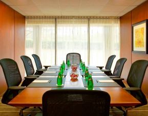 One of Westin Atlanta Airport Hotel’s meeting rooms, with long table, seating for eight, and a large window.