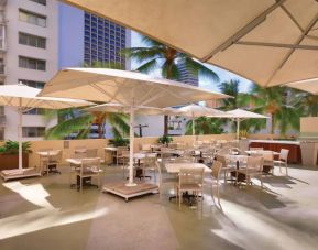 Guests at Hyatt Place Waikiki Beach can enjoy outdoor dining with plenty of shade from the sun.