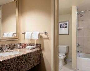 Private guest bathroom with shower and bath at Anaheim Marriott Suites.