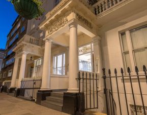 The nocturnal exterior of the Victoria Inn, including stylish white columns.