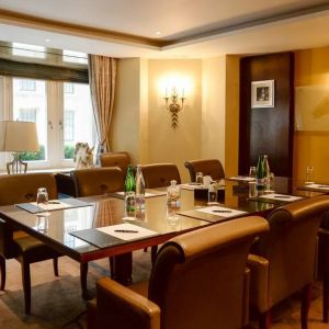 Well-lit boardroom meeting venue with space for around ten people.
