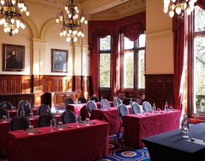 The River Room of The Royal Horseguards Hotel, a meeting space decorated with wood panels and chandeliers.