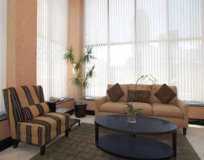 The hotel’s lounge lobby with comfortable seating, windows, and coffee table.