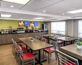 The hotel’s breakfast area has a hard floor and variety of table sizes for diners.