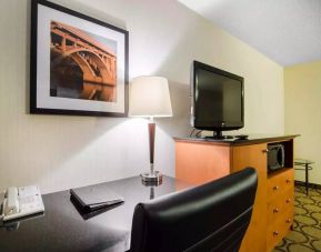 Guest room in the Comfort Inn Saskatoon, with workspace desk and chair and nearby TV.