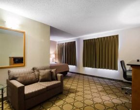 Guest room in the Comfort Inn Saskatoon, with double bed and sofa.