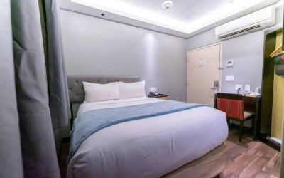 Madison LES Hotel room with double bed, and desk for working.