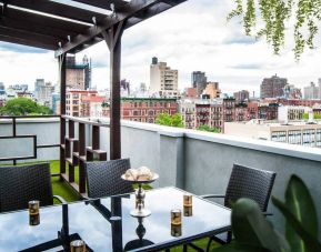 Outdoor terrace with table and chairs for relaxing/socializing.