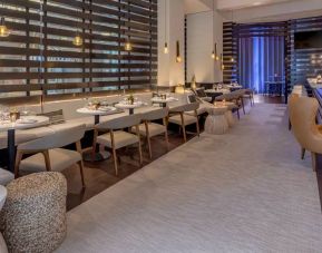 The hotel’s lobby bar, with mix of tall stools at the bar and soft seats around tables.