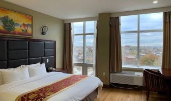 Guest room at the Queens Hotel, with double bed and large windows.