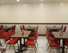 The hotel’s breakfast area, with hard floor and small tables.