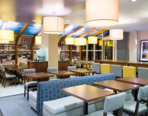 Blue and yellow colorful dining and lounge room at the Hampton Inn Manhattan - Madison Square Garden.