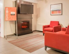 The hotel’s lobby has comfortable seating, a fireplace, and large TV screen.