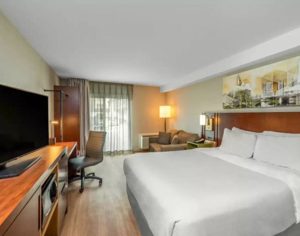 Comfort Inn Winnipeg Airport guest room including double bed and large television.