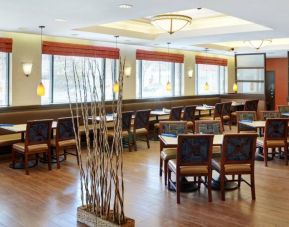 Peppermill Cafe is the hotel’s on-site dining venue, with tables for four and large windows.