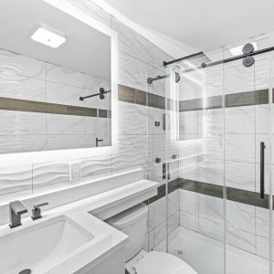 Guest bathroom with shower at Hotel Opus Bronx.