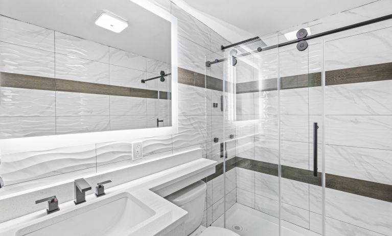 Guest bathroom with shower at Hotel Opus Bronx.