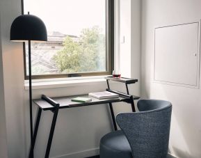 A little workspace, with desk, lamp, and window to ensure an abundance of light.