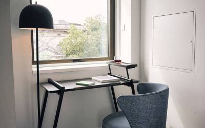 A little workspace, with desk, lamp, and window to ensure an abundance of light.