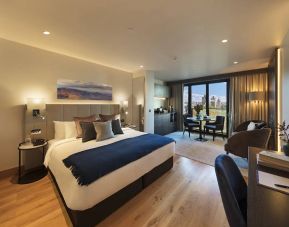 Large double bedroom in the Tower Suites By Blue Orchid Hotels, with workspace, window, and kitchenette.