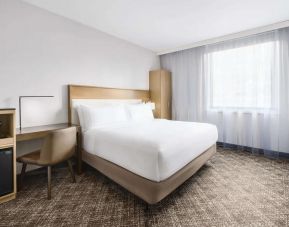 Guest room in the DoubleTree Times Square South, with double bed and workspace desk and chair.