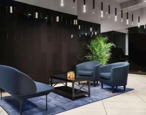 The hotel’s lobby, with comfortable chairs and sofa, plus coffee table.