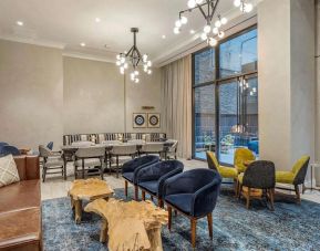 Lounge in the lobby of The Draper, Ascend Hotel Collection, with sofas, comfy chairs, and tables.