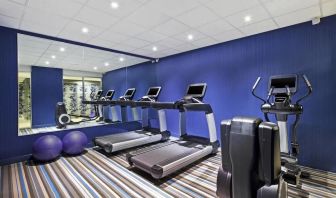 The Aloft Manhattan Downtown - Financial District’s exercise facility, featuring exercise balls and machinery.