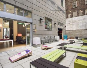 The hotel’s patio area, with plentiful seating and tall stools/tables.