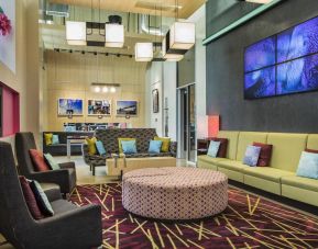 The hotel’s lounge, with comfortable chairs and sofas, and many cushions.