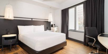 Guest room in the Hyatt Union Square New York, with large bed, window, and workspace.