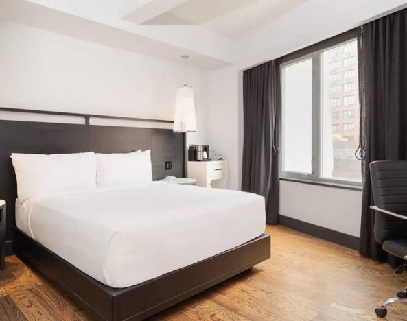 Guest room in the Hyatt Union Square New York, with large bed, window, and workspace.