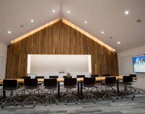 A conference room in the Hyatt Union Square New York with space for over a dozen attendees around a long table.