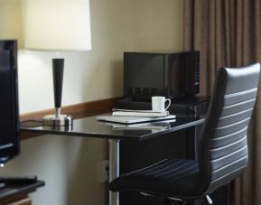 An in-room workspace at the Comfort Inn Belleville, including desk, chair, and lamp.