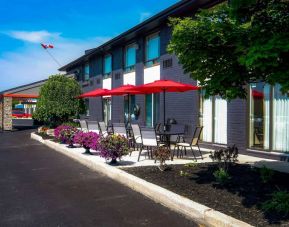 Comfort Inn Belleville’s exterior has shaded tables and chairs for outside dining and socializing.