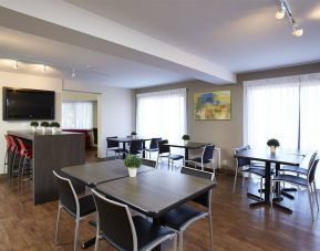 The hotel’s dining area has a hard floor, and is well-lit due to large windows.