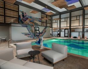 The Beeman Hotel’s indoor pool has seating and tables nearby.