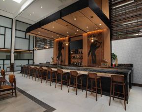 The hotel bar has traditional tall bar stools and a wide range of beverages.