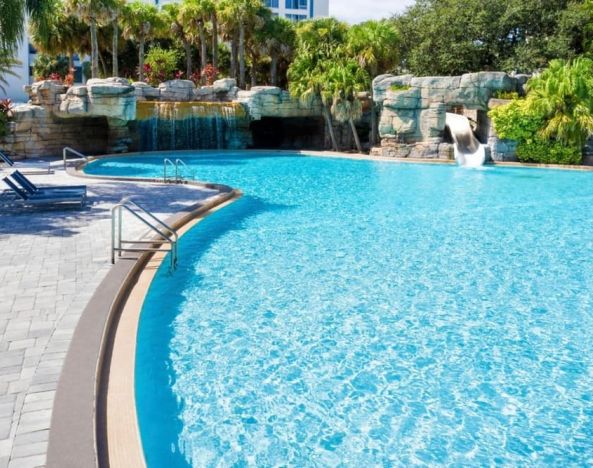 Large outdoor pool with sunbeds at Delta Hotels Orlando Celebration.