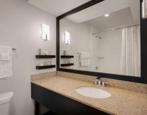 Private guest bathroom with shower at Delta Hotels Orlando Celebration.