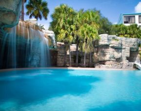 Stunning outdoor pool with waterfall feature at Delta Hotels Orlando Celebration.