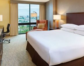 Delux king bed with TV and business desk at DoubleTree San Antonio Airport.