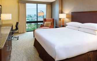 Delux king bed with TV and business desk at DoubleTree San Antonio Airport.