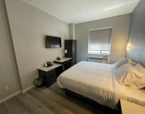 King Hotel Brooklyn guest room, featuring double bed and window with blind.