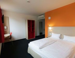 Spacious king bedroom with work station at B&B Hotel Frankfurt-Airport.