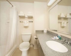 Private guest bathroom with shower at Best Western Seattle Airport Hotel.