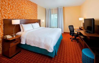 Delux king bed with business desk at Fairfield Inn & Suites Houston Hobby Airport.