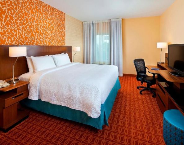 Delux king bed with business desk at Fairfield Inn & Suites Houston Hobby Airport.