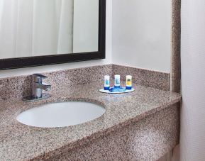 Private guest bathroom with shower at Fairfield Inn & Suites Houston Hobby Airport.